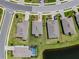 Aerial view of home with well-manicured lawn and landscaping; pool; view of the pond, and a fenced yard at 5329 Senza Trl, Palmetto, FL 34221