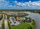 Beautiful aerial view of community clubhouse, pool, playground, parking and lakefront homes at 5329 Senza Trl, Palmetto, FL 34221