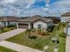 Aerial view of a lovely home with landscaped front yard and a brick driveway in a quiet neighborhood at 5329 Senza Trl, Palmetto, FL 34221