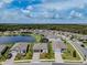 Aerial view of homes surrounding a pond with well-manicured lawns, sidewalks, and beautiful landscaping at 5329 Senza Trl, Palmetto, FL 34221