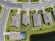 Aerial view of home with well-manicured lawn and landscaping; pool; view of the pond, and a fenced yard at 5329 Senza Trl, Palmetto, FL 34221