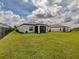 Spacious backyard with healthy green lawn, fence and screened-in lanai at 5329 Senza Trl, Palmetto, FL 34221