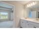 Main bathroom with dual sinks and a view into the bedroom at 5329 Senza Trl, Palmetto, FL 34221