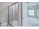 Bathroom displays a glass-enclosed shower and toilet at 5329 Senza Trl, Palmetto, FL 34221