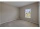 Neutral bedroom featuring carpeted flooring, a window, and light-colored walls at 5329 Senza Trl, Palmetto, FL 34221