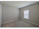 Bedroom with neutral walls and carpet, a window with blinds and a built in closet at 5329 Senza Trl, Palmetto, FL 34221