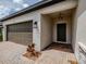 Exterior view of front entryway with brick driveway and star pendant light at 5329 Senza Trl, Palmetto, FL 34221
