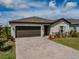Charming one-story home featuring a brick driveway and professionally landscaped front yard at 5329 Senza Trl, Palmetto, FL 34221