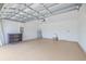 A spacious garage with epoxy floors, white walls, storage and utility sink at 5329 Senza Trl, Palmetto, FL 34221