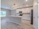 Kitchen boasts modern white cabinets, stainless appliances, island, and stylish pendant lighting at 5329 Senza Trl, Palmetto, FL 34221