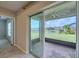 View from inside the house to the lanai, featuring a brick floor and view of the backyard and lake at 5329 Senza Trl, Palmetto, FL 34221