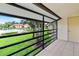 Tiled balcony with views of the pool and community landscape at 5785 Gardens Dr, Sarasota, FL 34243