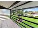 Balcony view overlooking community pool, lawn, and tropical landscaping at 5785 Gardens Dr, Sarasota, FL 34243
