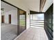 Open balcony offering a glimpse of the bright living area at 5785 Gardens Dr, Sarasota, FL 34243