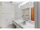 Bright bathroom with a tub and shower combination, updated lighting, and a white vanity at 5785 Gardens Dr, Sarasota, FL 34243