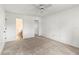 Spacious carpeted bedroom with a ceiling fan, walk-in closet, and attached bathroom at 5785 Gardens Dr, Sarasota, FL 34243