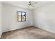 Cozy bedroom featuring neutral carpet, a ceiling fan, and a pool view at 5785 Gardens Dr, Sarasota, FL 34243