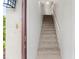 Bright entryway showcasing a stairway with neutral carpeting and fresh white walls for an open, inviting feel at 5785 Gardens Dr, Sarasota, FL 34243