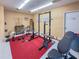 This gym contains exercise equipment, weights, and a weight rack offering a dedicated fitness space at 5785 Gardens Dr, Sarasota, FL 34243