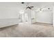 Open-concept living room with view of kitchen and bright, neutral decor at 5785 Gardens Dr, Sarasota, FL 34243