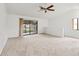 Spacious living room with vaulted ceilings and sliding glass doors to patio at 5785 Gardens Dr, Sarasota, FL 34243