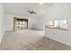 Open-concept living room with view of patio and a convenient kitchen pass-through at 5785 Gardens Dr, Sarasota, FL 34243