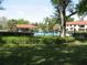 Serene view of a sparkling pool bordered by greenery and trees at 5785 Gardens Dr, Sarasota, FL 34243