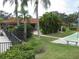 A shuffleboard court located near the building with tropical palms and mature landscaping at 5785 Gardens Dr, Sarasota, FL 34243