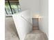 Clean stairway with neutral carpet and white walls, providing a bright transition to the upper level at 5785 Gardens Dr, Sarasota, FL 34243