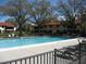 The sparkling community pool has lounge chairs and lush greenery making it a perfect place for relaxation at 5785 Gardens Dr, Sarasota, FL 34243
