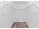 Walk-in closet with a carpeted floor and wire shelving on three walls at 5785 Gardens Dr, Sarasota, FL 34243