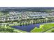 Expansive aerial view of a community featuring houses, multiple lakes, and lush green trees at 5830 100Th E Ave, Parrish, FL 34219