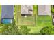 Aerial view of the fenced backyard with lush greenery and a pool nearby at 5830 100Th E Ave, Parrish, FL 34219