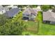Aerial view of a fenced backyard with ample green space and screened in back porch at 5830 100Th E Ave, Parrish, FL 34219