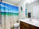 Bright bathroom with a shower and a sink with a mirror at 5830 100Th E Ave, Parrish, FL 34219