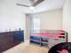 This bedroom has a ceiling fan, a bed frame that can be used as storage and drawers at 5830 100Th E Ave, Parrish, FL 34219