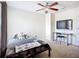 This bedroom has a ceiling fan and a desk to use as a study area at 5830 100Th E Ave, Parrish, FL 34219