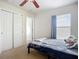 This bedroom has a walk-in closet, a window that allows natural light to flow in at 5830 100Th E Ave, Parrish, FL 34219
