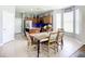 Open-concept kitchen and dining area featuring dining table, chairs, and island at 5830 100Th E Ave, Parrish, FL 34219