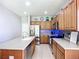 Spacious kitchen with stainless steel appliances, wooden cabinetry, island, and ample counter space at 5830 100Th E Ave, Parrish, FL 34219