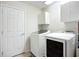 Clean laundry room with a washer, dryer, and storage cabinets at 5830 100Th E Ave, Parrish, FL 34219