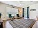 Sun-filled living room with a stylish rug, comfortable chairs, and sliding glass doors at 5830 100Th E Ave, Parrish, FL 34219