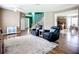 Open-concept living room featuring hardwood floors, cozy seating, and access to kitchen and staircase at 5830 100Th E Ave, Parrish, FL 34219
