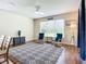 Bright living room featuring a ceiling fan, two chairs, a rug, and a window at 5830 100Th E Ave, Parrish, FL 34219