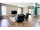 Comfortable living room featuring hardwood floors, neutral walls, and two black leather recliners at 5830 100Th E Ave, Parrish, FL 34219