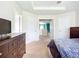 Well-lit main bedroom with neutral decor, featuring multiple doorways and hallway access at 5830 100Th E Ave, Parrish, FL 34219