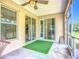Comfortable screened porch with artificial turf and sliding glass doors at 5830 100Th E Ave, Parrish, FL 34219