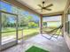 Relaxing screened porch with a hammock and ceiling fan overlooking the backyard at 5830 100Th E Ave, Parrish, FL 34219