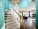 Open staircase leading to a spacious living area with hardwood floors and ample natural light at 5830 100Th E Ave, Parrish, FL 34219