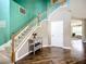 Carpeted staircase leading to an open floor plan with hardwood floors and plenty of light at 5830 100Th E Ave, Parrish, FL 34219